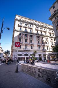 a large white building on a city street with a sign at Bellorizzonte in Naples