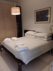 a bedroom with a bed with towels on it at baricarulli52 in Bari