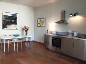 a kitchen with a table and a counter top at The Art Residence Maastricht in Maastricht