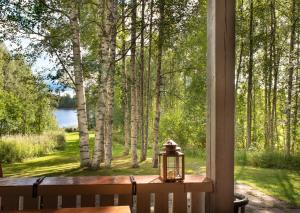 a lantern sitting on a table in front of a window at Koivuranta in Räätäniemi +4 photos