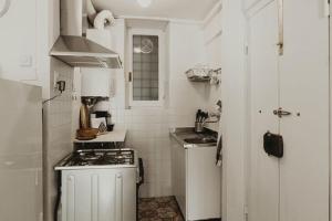 a small kitchen with a stove and a sink at “Ivory house”with sea view in Manarola