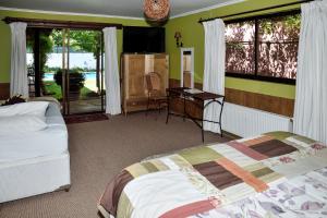 um quarto com duas camas, uma escrivaninha e uma televisão em Hostal Cepa Noble em Santa Cruz mais 30 fotografias