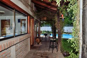 an external walkway leading to a house with a swimming pool at Hostal Cepa Noble in Santa Cruz
