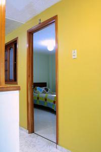 a room with a door leading to a bedroom at Hostel Casa Alb in Bogotá