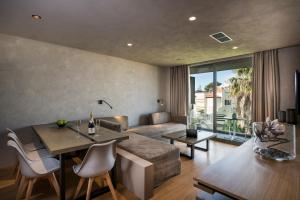 a living room with a couch and a table at Icarus Hotel in Kalamaki