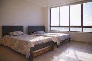 Ein Bett oder Betten in einem Zimmer der Unterkunft Apartamento DUPLEX OCEAN BLUE 1