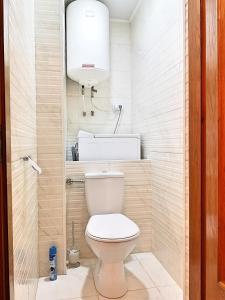 a small bathroom with a toilet and a light at Nice apartment on street Alexandru cel bun 108 in Chişinău