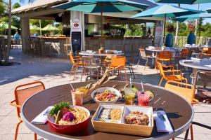 a table with bowls of food and drinks on it at Naples Grande Beach Resort in Naples