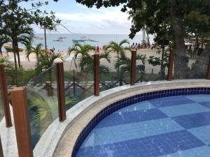 a swimming pool with a view of the beach at Porto Praia do Forte in Praia do Forte