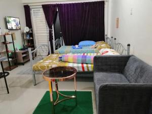 a living room with a couch and a bed at Condo Stay at Paranaque with Unlimited WIFI v3 in Manila