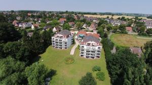 an aerial view of a large house on a green field at Penthouse-Suite am Plöner See in Ascheberg