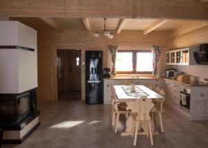 a kitchen with a table and chairs and a stove at Dwór Pan Tadeusz in Orawka