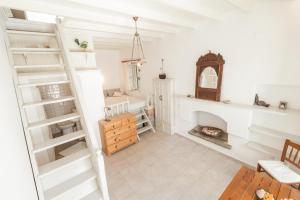 a living room with white walls and a fireplace at Casa Rinio in Symi