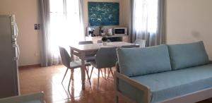 a living room with a couch and a table with chairs at Minies Beach Villas in Minia