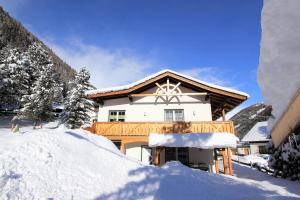 a house with snow in front of it at Ferienhaus Weixelbraun in Mallnitz