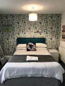 a bedroom with a bed with a blue head board at Sandford Promenade in Blackpool