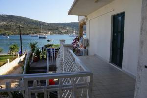 a balcony of a house with a view of the water at One-Bedroom Apartment in Vinisce I in Vinišće