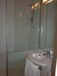 a bathroom with a sink and a shower at ibis Besançon Marchaux in Marchaux