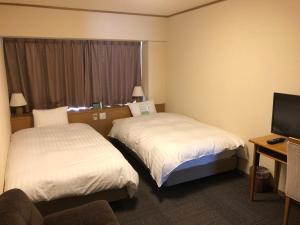 Dormy Inn PREMIUM Kushiro客房内的一张或多张床位