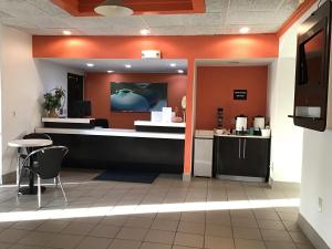 a lobby of a restaurant with a counter and chairs at 7 boutique hotel in Pratt