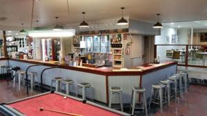 a bar in a restaurant with stools at Augathella Palms Motel in Augathella