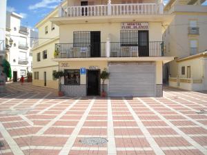 a large brick building with a large window at Hostal Flor Blanco in Torremolinos