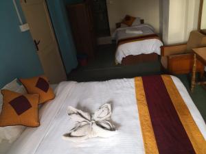 a bedroom with a bed with towels on it at Holyland Guest House in Kathmandu