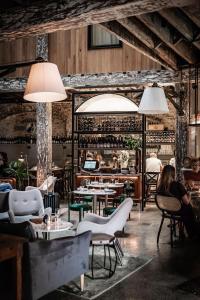a restaurant with tables and chairs and people sitting at The Woolstore 1888 by Ovolo in Sydney