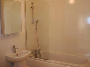 a bathroom with a shower and a sink and a tub at Lantana Resort Barbados by Island Villas in Saint James