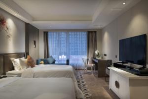 Postel nebo postele na pokoji v ubytování Paco Hotel Dongpu Guanghzou -Free Shuttle Bus for Canton Fair