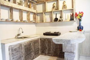 uma cozinha com armários de madeira e uma bancada de mármore em The Pasga Villas Ubud em Ubud