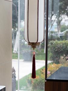 a window with a curtain and a tassel on it at SHANGHAI-DECO Hotel-Free shuttle bus to Pudong Airport and Disneyland in Shanghai