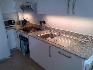 a kitchen with a sink and a counter top at Lantana Resort Barbados by Island Villas in Saint James