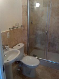 a bathroom with a shower and a toilet and a sink at Lantana Resort Barbados by Island Villas in Saint James