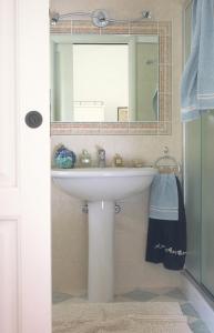 a bathroom with a white sink and a mirror at Agriturismo Valcrosa in Diano Castello