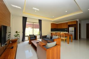 a living room with a couch and a table at Bamboo Garden Villa in Rawai Beach