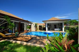 a swimming pool in the backyard of a villa at Bamboo Garden Villa in Rawai Beach