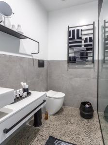 a bathroom with a toilet and a sink and a mirror at Waters Edge B&B in Whitianga