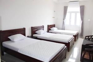 Ein Bett oder Betten in einem Zimmer der Unterkunft Hoang Gia Doc Let
