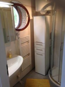 a bathroom with a sink and a toilet and a mirror at Idyllisches Haus an Weingärten 30 m von Kiesstrand in Podobuče +76 photos