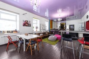 a kitchen and living room with a table and chairs at FunKey Hostel in Novosibirsk