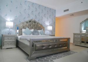 a bedroom with a large bed and two night stands at Stunning 5* 4BR-Oceanfront-Apartment in Dubai