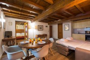 a kitchen and a living room with a table and chairs at Calzaiuoli loft in Florence