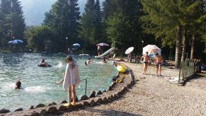 a group of people playing in a swimming pool at Gostišče Vančar in Bovec