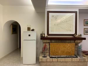a living room with a fireplace with a picture on the wall at La Residenza dei Papi in Papigno