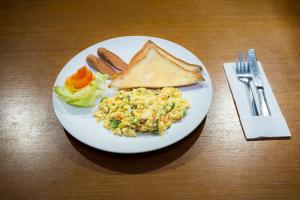 a plate of food with eggs toast and bread at Ani's Villas in Ubud +26 photos