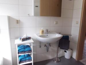 a bathroom with a sink and a mirror and towels at Ferienhaus 1 An der Rodach in Steinwiesen +27 photos