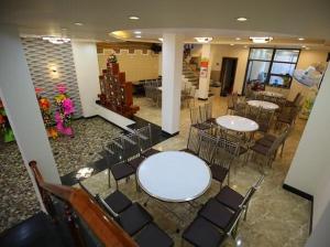 a room with tables and chairs in a building at Khách sạn Hoàng My in Tuy Hoa