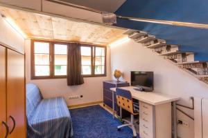 a room with a desk with a computer and a staircase at Home in Tramuntana in Port des Canonge 