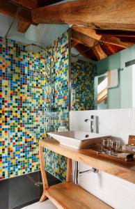 a bathroom with a sink and colorful tiles on the wall at La Casona del Viajante - Adults Only in Villabajo
